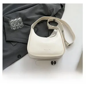 Flat lay of white leather hobo bag with New York print next to a smartphone
