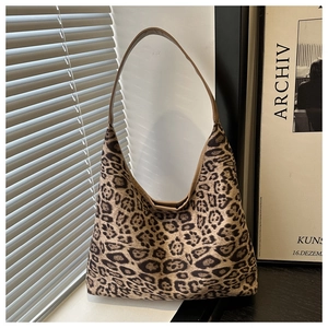 Leopard print hobo bag with artistic shadow effect on suede fabric showing detail