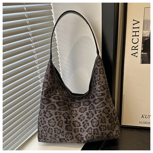 Detail of grey leopard print shoulder bag featuring premium texture and leather strap