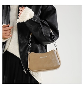 Detail of camel crescent shoulder bag with metal chain strap and fashion lettering
