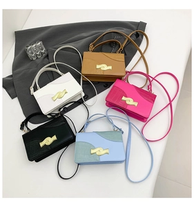 Close-up of small crossbody bags in five colors with textured faux crocodile leather
