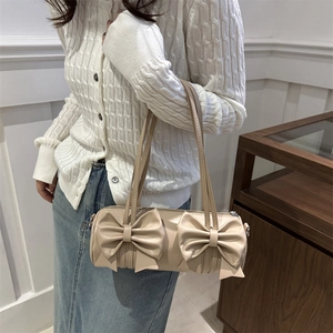 French style beige cylindrical shoulder bag with double bows and matte PU leather finish