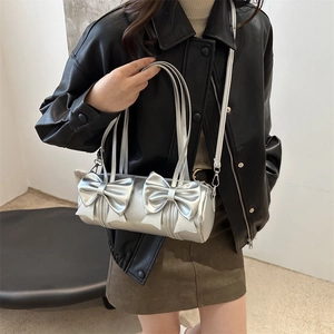 Silver metallic barrel bag with double bows and adjustable shoulder strap for women