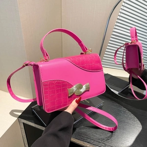 Fuchsia crossbody chain bag with crocodile texture and gold metal buckle shown from front and back