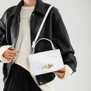Elegant white crossbody bag with crocodile texture and gold wavy metal lock for women