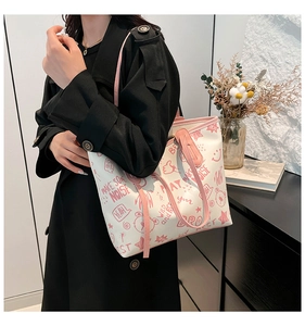 Close-up of cute white tote bag with pink graffiti illustrations worn by a model