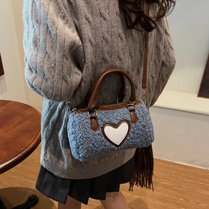 Blue fleece cylinder bag with white heart detail and brown leather straps for autumn winter