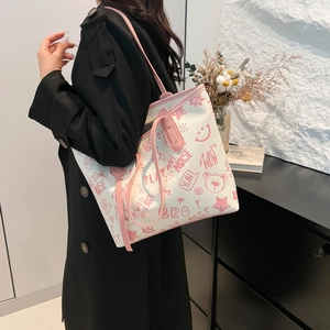Grand sac cabas beige avec bretelles roses et motifs graffiti sur une femme