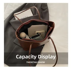 Interior view showing the large capacity and zipper pocket of this brown faux leather tote bag