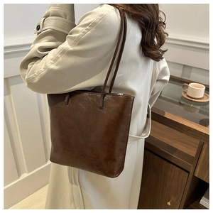 Macro detail of high-quality brown oil-wax leather tote bag with smooth texture