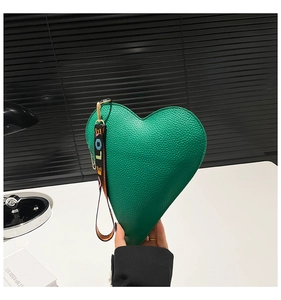 Detail of green heart handbag with lychee texture and LOVE printed wrist strap