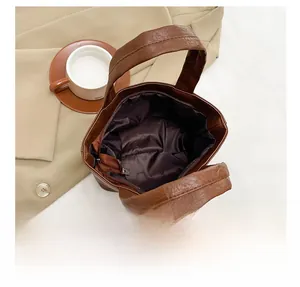 Detail of the brown soft leather handbag showing the spacious interior and zipper closure