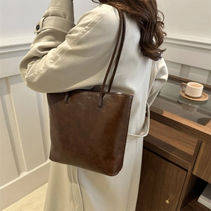 Retro dark brown large capacity faux leather tote bag for women in lifestyle setting