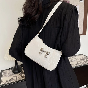 Chic off-white crescent underarm bag with cloud-like pleats and silver metal bow detail