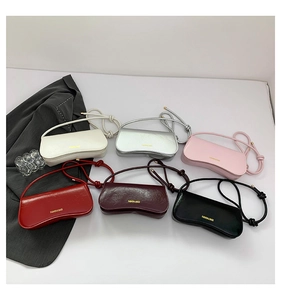 Flat lay of minimalist leather underarm bags in six colors with fashion gold stamping