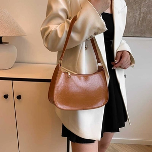 Brown half-moon hobo bag in vintage cracked faux leather with golden metallic hardware