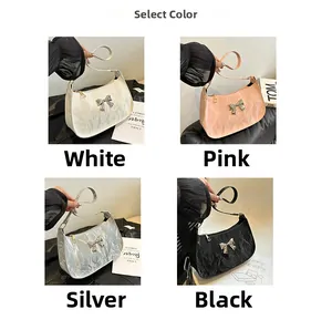 Detail of trendy crescent bags in white, pink, silver, and black with bow accents