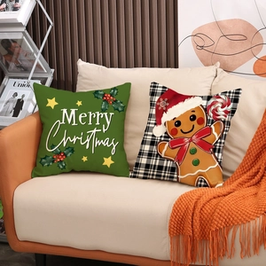 Christmas pillow covers with gingerbread man and Merry Christmas print on a beige sofa