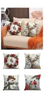 Detailed view of four Christmas pillow covers featuring snowmen and reindeer on linen fabric
