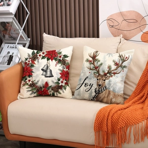 Set of two Christmas throw pillow covers with reindeer and bell wreath for holiday sofa decor
