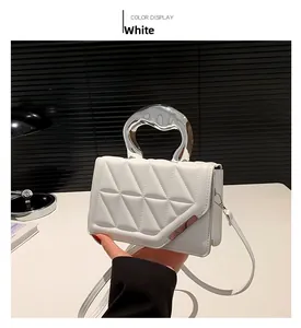 Close-up of white quilted handbag with a unique silver liquid metal handle and strap