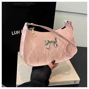 Detail of pink marble pattern crescent bag with a silver metal bow accent