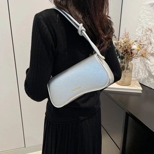 Silver metallic textured shoulder bag with knotted strap detail and elegant rectangular shape