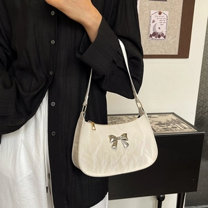 Chic cream crescent underarm bag with pleated texture and silver bow decoration