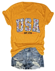 Detailed close-up of USA EST. 1776 floral print on a mustard yellow cotton T-shirt