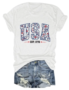 Detail of USA EST. 1776 floral print on white t-shirt with distressed denim shorts