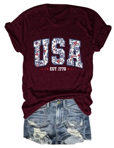 Close-up of USA EST. 1776 graphic print on burgundy cotton t-shirt with floral details
