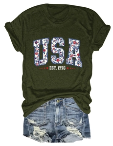 Flat lay of olive green USA flower print T-shirt and distressed denim shorts outfit set