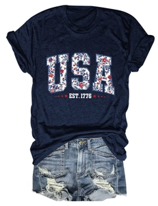 Detail of USA EST. 1776 graphic print with red stars on navy blue short sleeve t-shirt