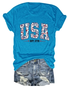 Close-up of USA EST. 1776 floral graphic on bright blue crewneck short sleeve T-shirt