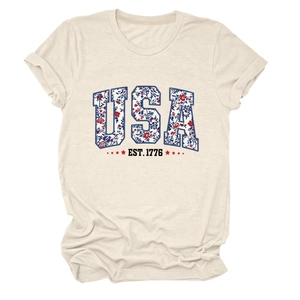 Close-up of USA EST 1776 floral letters and star print on cream cotton t-shirt
