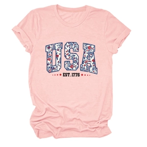 Detail of pink USA EST. 1776 t-shirt with floral print lettering and rolled sleeves