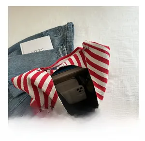 Interior view showing large capacity of the red zebra stripe canvas tote with daily essentials