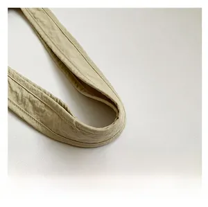 Detail of soft khaki tote bag shoulder strap with durable double-row stitching