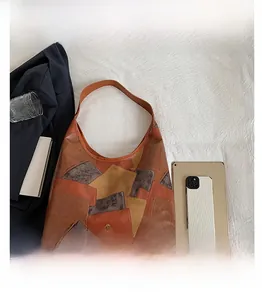Flat lay of vintage patchwork tote bag with tablet and phone for size comparison