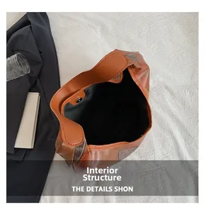 Macro view of tote bag interior featuring magnetic snap closure and dark fabric lining
