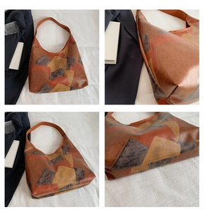 Detail view of large patchwork leather tote bag in retro brown color block style