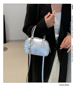 Detailed view of metallic silver bowling bag with smooth finish and adjustable strap