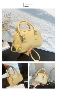Detail view of yellow boston bag featuring vintage pleated texture and silver hardware