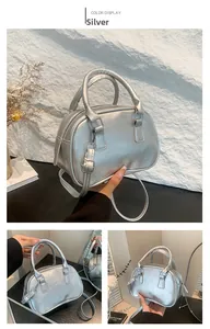 Detail of silver metallic pleated tote bag showing versatile strap and modern texture