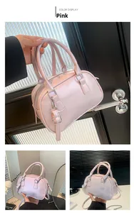 Detail view of pink PU leather Boston bag with silver hardware and shoulder strap