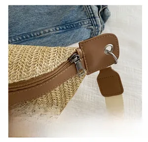 Close-up of smooth silver metal zipper and woven texture on a summer crossbody bag