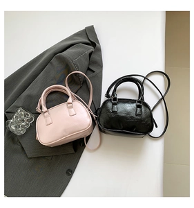 Minimalist mini Boston bag details in pink and black colors with soft leather texture
