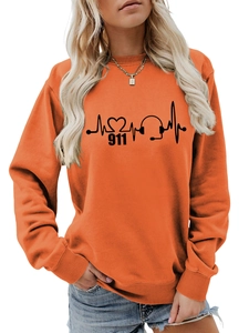 Close-up of orange crewneck sweatshirt featuring a black 911 heartbeat graphic print