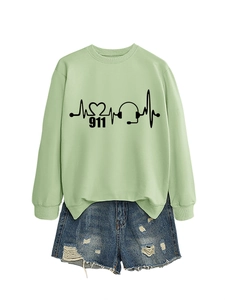 Detail of light green 911 sweatshirt with EKG heart graphics and frayed denim shorts