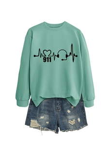 Detailed view of mint green sweatshirt featuring black EKG heart and headphone prints
